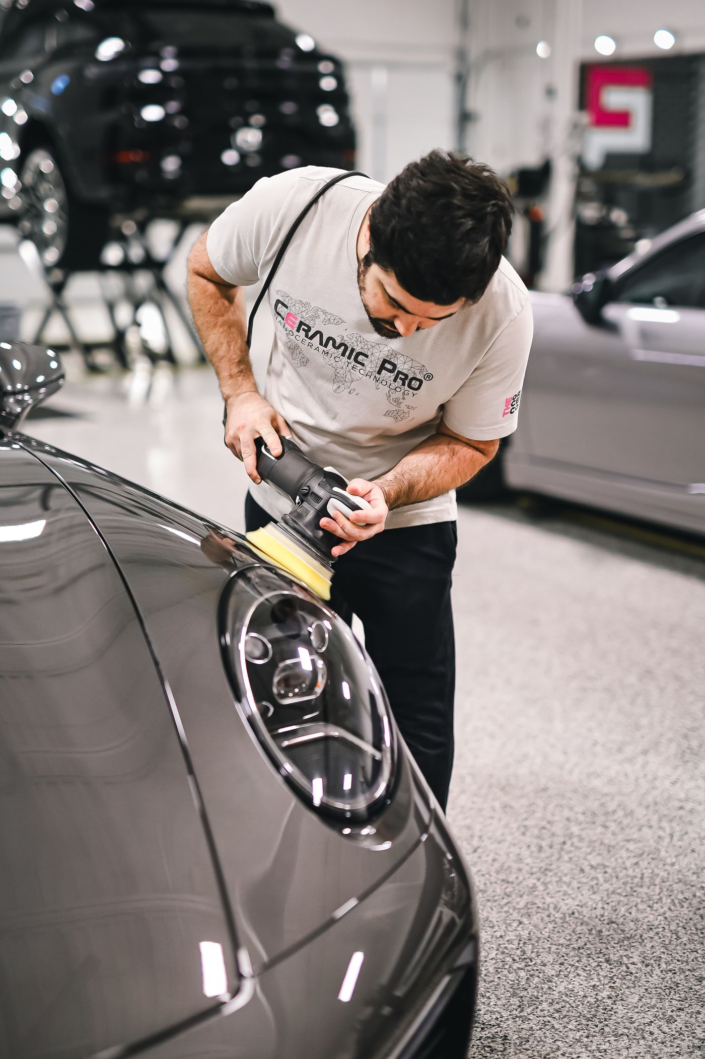 Technician polishing a car panel